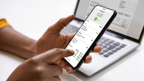 Xero simplifies supplier payment management through a person holding a smartphone with an invoice on it. - JacRox