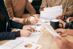 A group of people strategizing trusts and tax planning at a table.