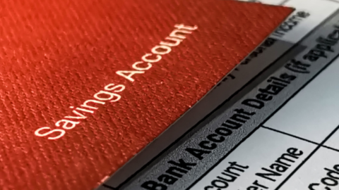 A bank reconciliation is being performed on a paper with a savings account on top. - JacRox