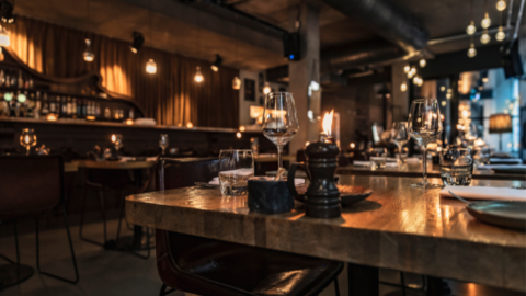 A restaurant with wooden tables - JacRox