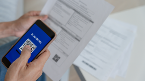 A person using a smartphone for managing supplier invoices. - JacRox