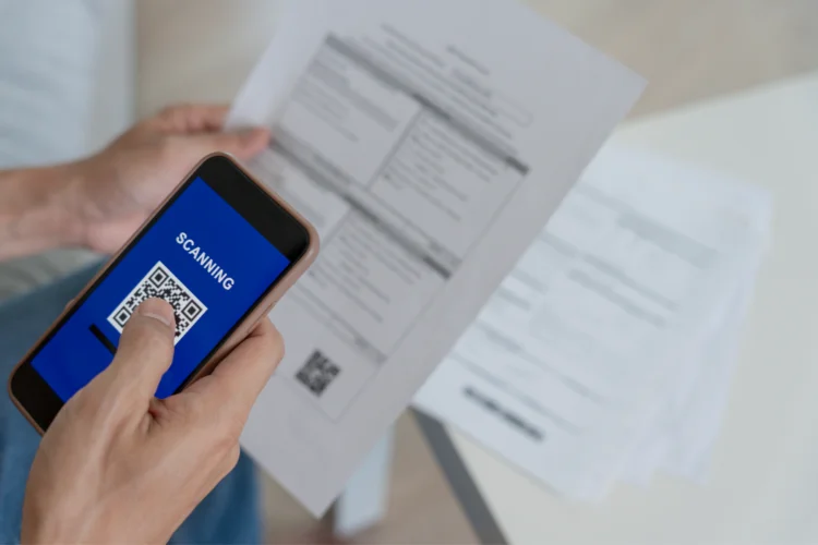A person using a smartphone for managing supplier invoices. - JacRox