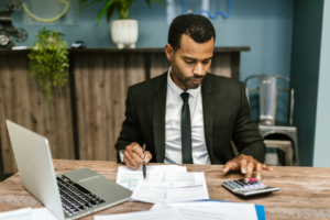 A man in a suit sitting at a desk