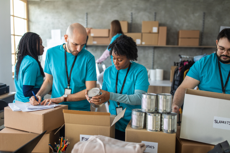 A group of people packing boxes in an office for a non-profit organization.